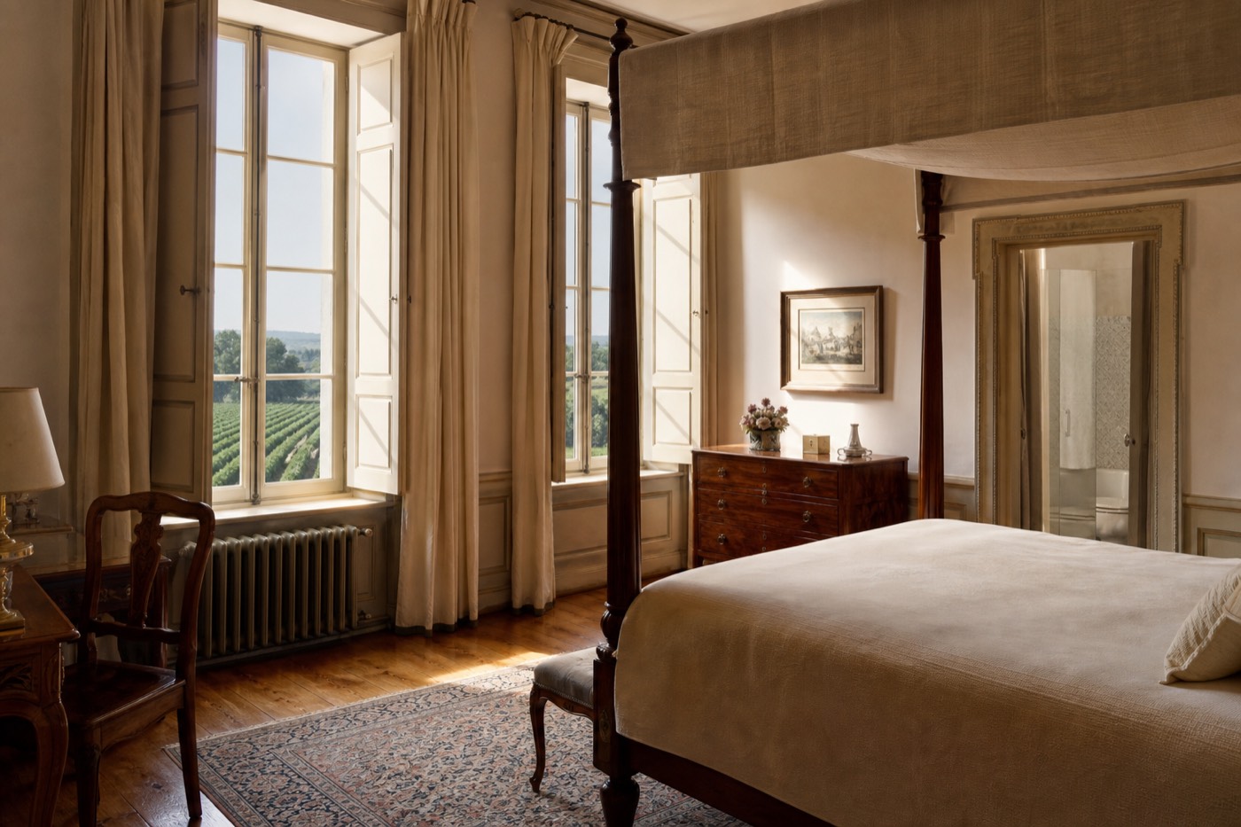 An elegant guest bedroom inside a historic Bordeaux wine château, windows overlooking vineyard rows